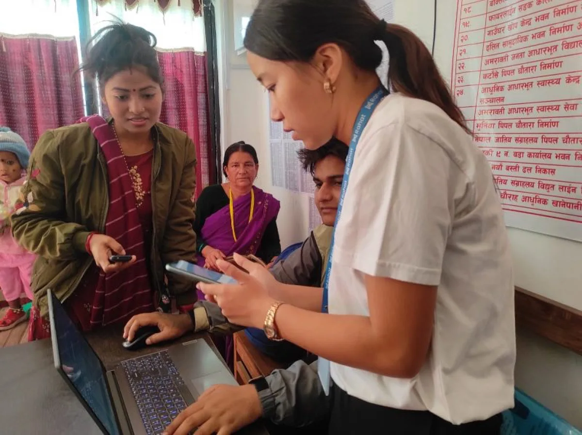 Team member interacting with beneficiaries during UNICEF AidLink program